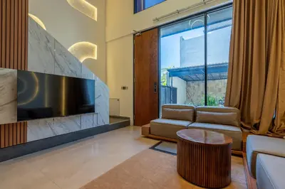 a living room with a couch and a tv at 1BR Modern Loft near Airport in Pesanggaran