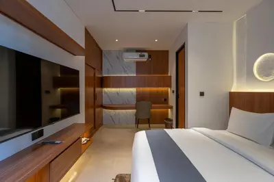 a hotel room with a bed and a desk at 2BR Modern Suites near Airport in Pesanggaran