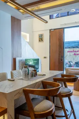 a kitchen with a large marble counter and chairs at 2BR Modern Suites near Airport in Pesanggaran