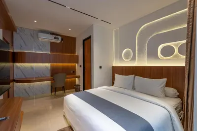 a hotel room with a bed and a desk at 2BR Modern Suites near Airport in Pesanggaran