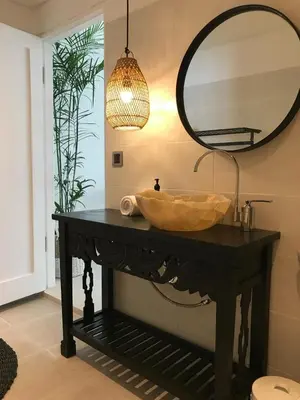 a bathroom with a wooden sink and a mirror at Villa Casa Mari in Seminyak