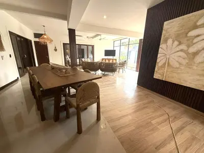 a dining room with a wooden table and chairs at Villa AYLA - Legian - 5 Bedrooms - 5 Bathrooms in Seminyak