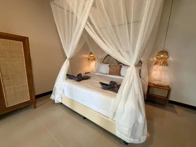 a bedroom with a white bed with a canopy at Villa AYLA - Legian - 5 Bedrooms - 5 Bathrooms in Seminyak