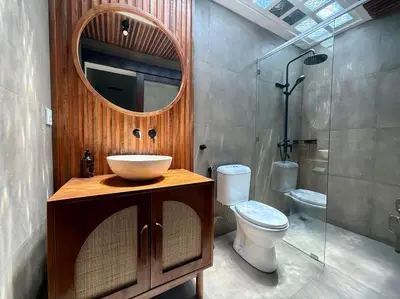a bathroom with a sink and a toilet and a mirror at Villa AYLA - Legian - 5 Bedrooms - 5 Bathrooms in Seminyak