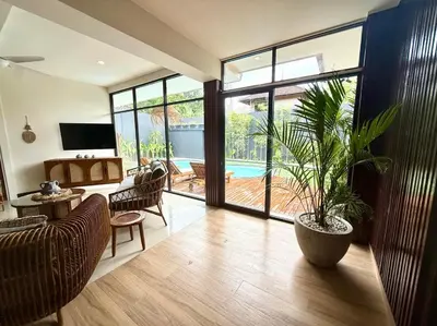 a living room with a potted plant in the middle at Villa AYLA - Legian - 5 Bedrooms - 5 Bathrooms in Seminyak