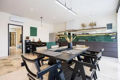 a kitchen and dining room with a table and chairs at Damai Suite Relax & Comfort in Canggu 3BR in Canggu