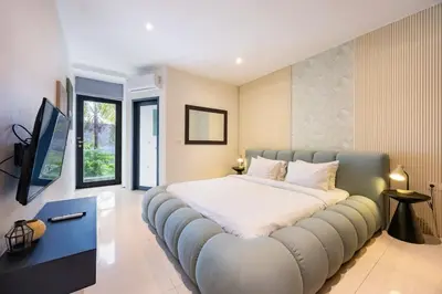 a large bedroom with a large bed in a room at Damai Suite Relax & Comfort in Canggu 3BR in Canggu