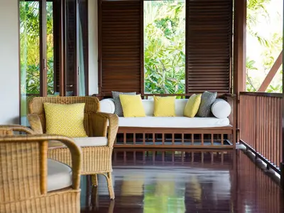 a porch with a couch and chairs on a patio at Villa Lilibel by Elite Havens in Seminyak