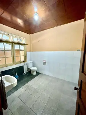a bathroom with a toilet and a sink at Nyoman Legian House in Legian