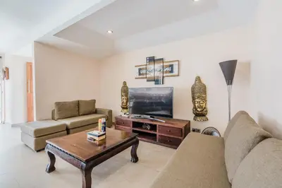 a living room with a couch and a tv at Villa Vista 3 Seminyak in Seminyak