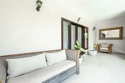 a living room with a couch and a mirror at 9 Bedroom Villa Vista Seminyak in Seminyak