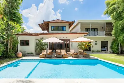 a villa with a swimming pool and a house at 9 Bedroom Villa Vista Seminyak in Seminyak