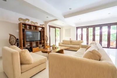 a living room with two couches and a television at 9 Bedroom Villa Vista Seminyak in Seminyak