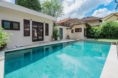 a swimming pool in front of a house at 10 Bedroom Villa Vista Seminyak in Seminyak