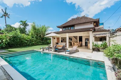 a villa with a swimming pool and a house at 10 Bedroom Villa Vista Seminyak in Seminyak