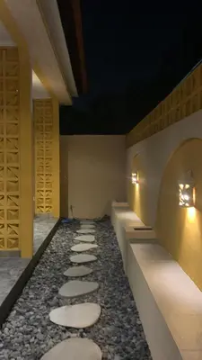 a row of stepping stones in a room with lights at Pradantara House in Nusa Dua