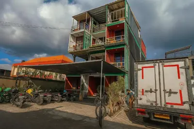 a building with bikes parked in front of it at trees inn Bali Denpasar in Denpasar