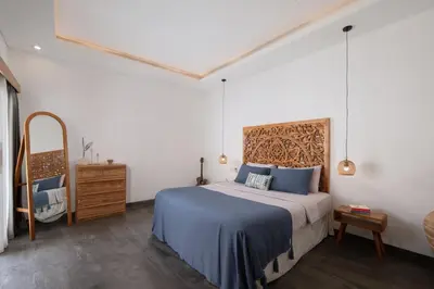 a bedroom with a bed and a dresser in it at Stylish 2BR Villa in Seminyak with Private Pool in Seminyak