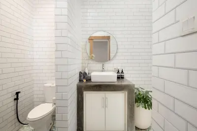 a bathroom with a sink and a toilet and a mirror at Stylish 2BR Villa in Seminyak with Private Pool in Seminyak