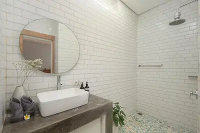 a white bathroom with a sink and a mirror at Stylish 2BR Villa in Seminyak with Private Pool in Seminyak