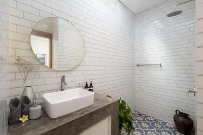 a white bathroom with a sink and a mirror at Stylish 2BR Villa in Seminyak with Private Pool in Seminyak