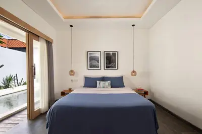a bedroom with a bed and a large window at Stylish 2BR Villa in Seminyak with Private Pool in Seminyak