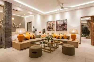 a living room with a couch and a table at Chill out in a luxurious 4 BR villa Seminyak in Seminyak