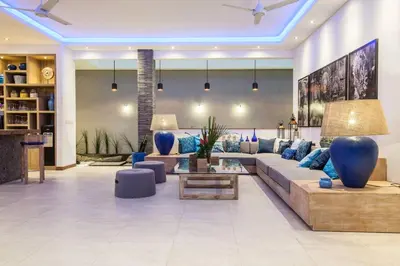 a living room with a couch and a table at Spacious 4 BR villa Seminyak garden and pool in Seminyak