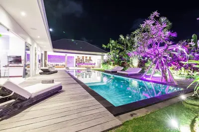 a villa with a swimming pool at night at Seminyak Modern villa 4 BR fully serviced 5 in Seminyak