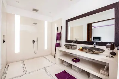a bathroom with two sinks and a mirror at Seminyak Modern villa 4 BR fully serviced 5 in Seminyak