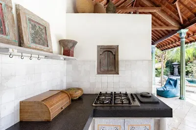 a kitchen with a stove and a counter top at Villa Aisis Seminyak in Seminyak