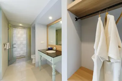 a bathroom with a sink and a mirror at Sans Vibes Astana Residence Seminyak in Seminyak