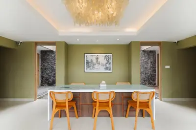 a dining room with a table and four chairs at Tan's Astana Villa's by The Lavana in Seminyak