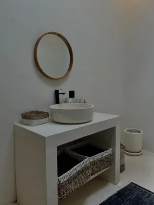 a bathroom with a sink and a mirror on the wall at Shine sunset villa in Kerobokan