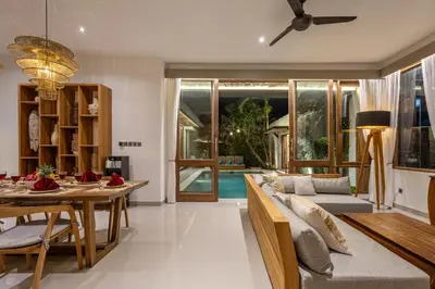 a living room with a couch and a table at Villa Tropea by BaliSuperHost in Seminyak
