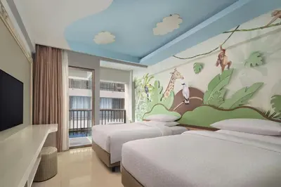 a bedroom with two beds and a mural of giraffes at Four Points by Sheraton Bali, Kuta in Kuta