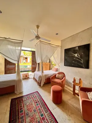 a bedroom with two beds and a ceiling fan at Tropical Villa Batik - Large Garden & Pool, Concierge! 3mins to Beach, Clubs, Cafes in Seminyak
