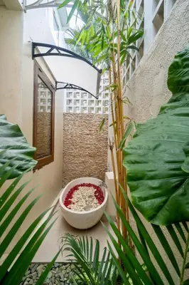 a bowl of food sitting on a floor next to plants at Tropical Villa Batik - Large Garden & Pool, Concierge! 3mins to Beach, Clubs, Cafes in Seminyak