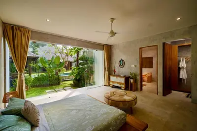a bedroom with a bed and a large window at Tropical Villa Batik - Large Garden & Pool, Concierge! 3mins to Beach, Clubs, Cafes in Seminyak