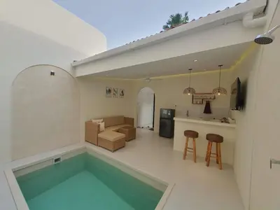 a kitchen and a living room with a swimming pool at Villa Kiara Sanur in Sanur
