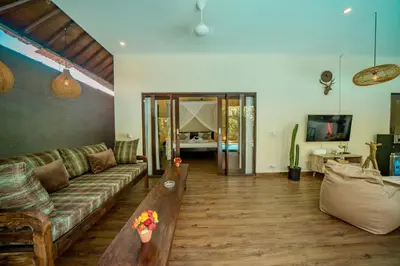 a living room with a couch and a table at Villa Kiwi Seminyak in Seminyak