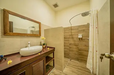 a bathroom with a sink and a shower at Villa Kiwi Seminyak in Seminyak