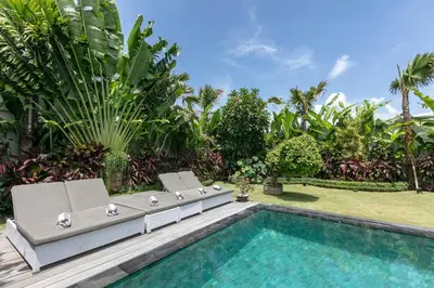 a backyard with a swimming pool and a villa at Amazing 4 BR villa with garden, pool in Seminyak in Seminyak