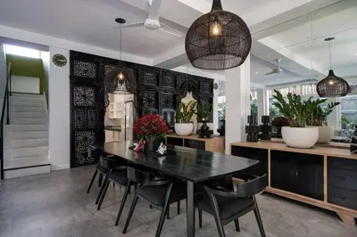 a dining room with a black table and chairs at 4BR Group Holiday, Walk to Fitness, Food, Beach in Seminyak