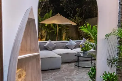 a living room with a couch and an umbrella at Villa Rama by JB Villas in Seminyak