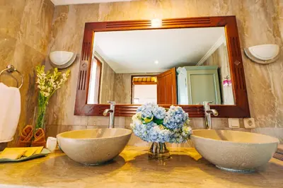 a bathroom with two sinks and a mirror at Villa Leona Seminyak in Seminyak