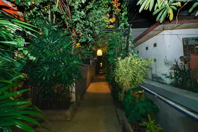 a hallway in a garden with plants and trees at Villa Leona Seminyak in Seminyak