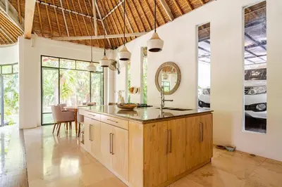 a kitchen with a counter and a dining room at Villa Bliss Umalas in Kerobokan