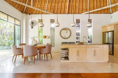 a kitchen and dining room with a table and chairs at Villa Bliss Umalas in Kerobokan