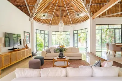 a living room with a white couch and a table at Villa Bliss Umalas in Kerobokan